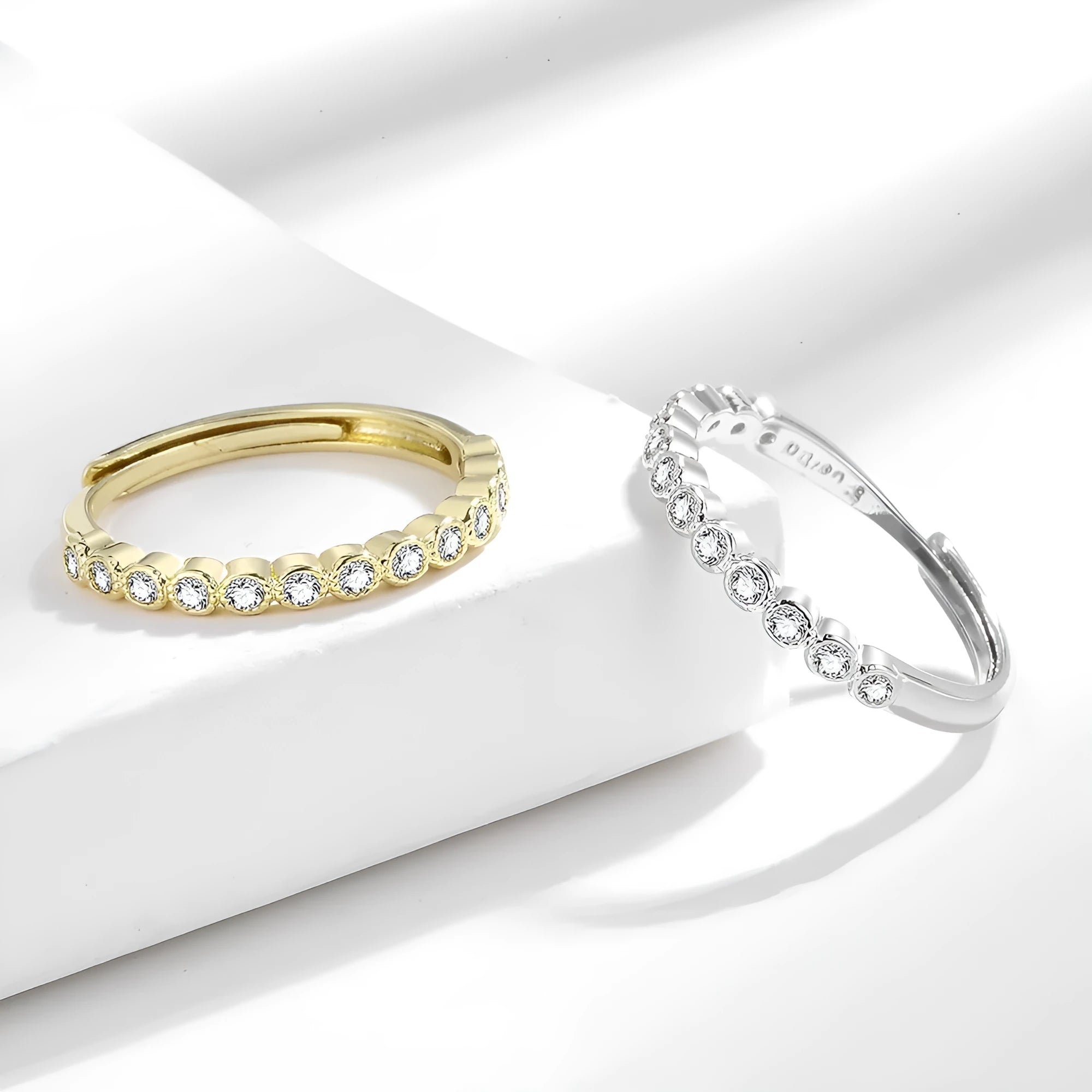 Women's geometric open ring with a diamond tail detail in a white gold or yellow gold colour finish.