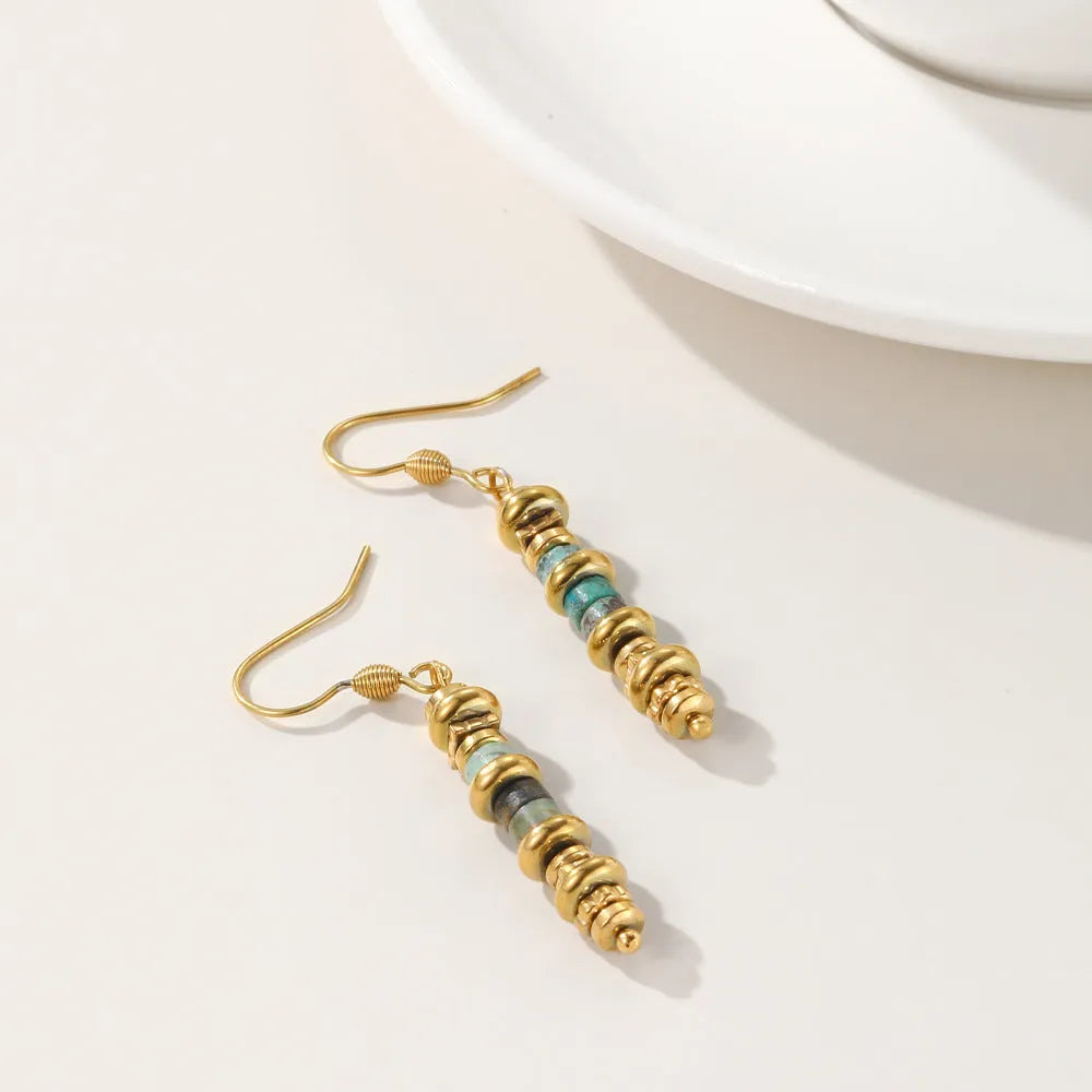 Geometric shaped titanium steel dangle earrings with a retro design on a white background.