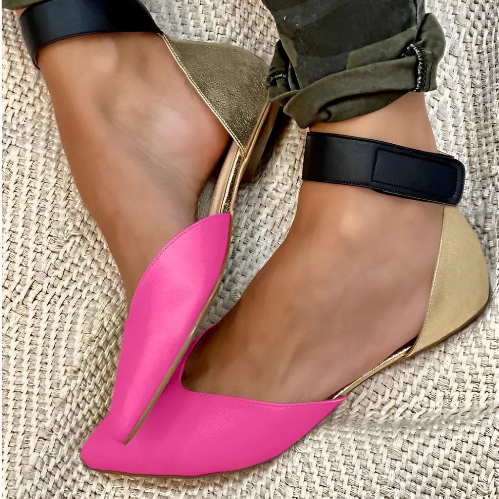 Women's beige velcro strap hollowed sandals with a flat heel on a plain background.
