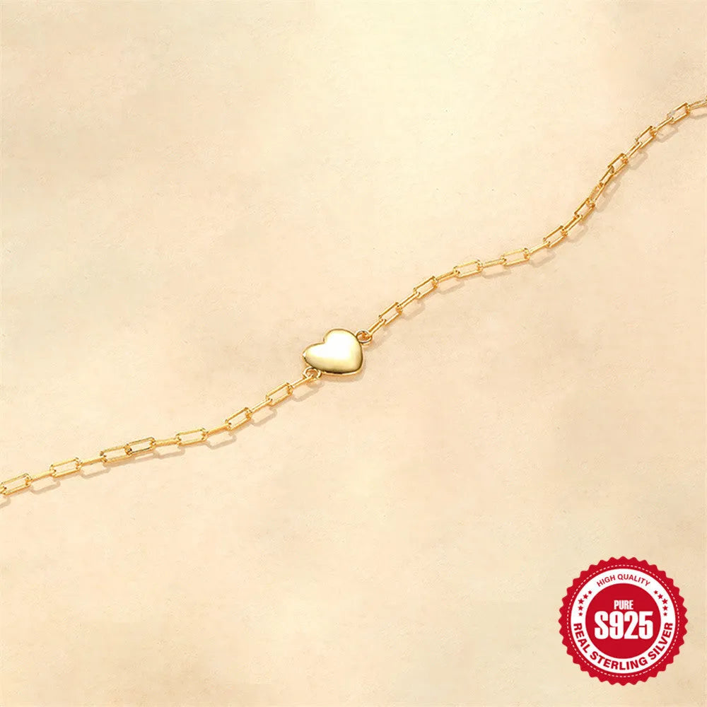 Gold plated sterling silver bracelet with geometric heart charm and clip chain clasp