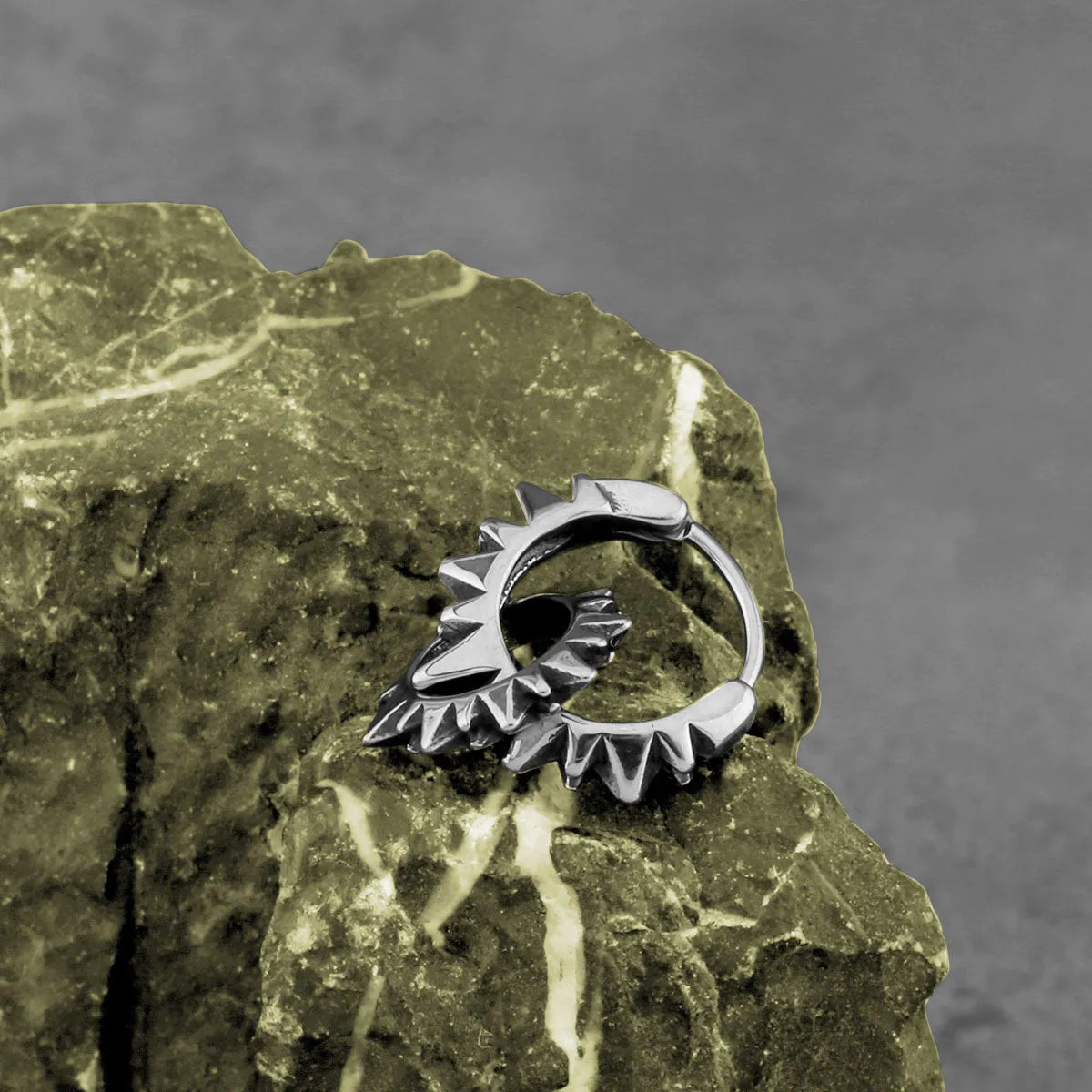 A pair of simple stainless steel round ring earrings with a polished steel colour finish.