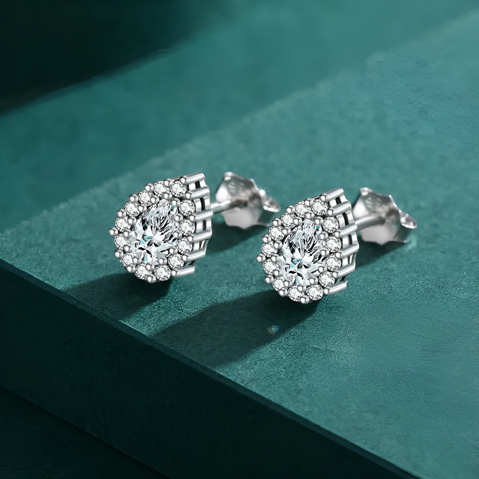 Women's drop shape ear studs in 925 sterling silver with diamond treatment
