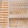 108 geometric pearl earrings with round elements and gold electroplated finish displayed as bulk set