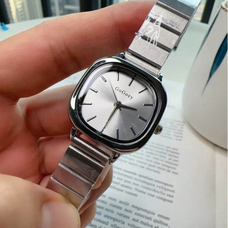 Women's quartz watch with metal case, steel strap and folding buckle, shown in gold or silver with green, white or gold surface