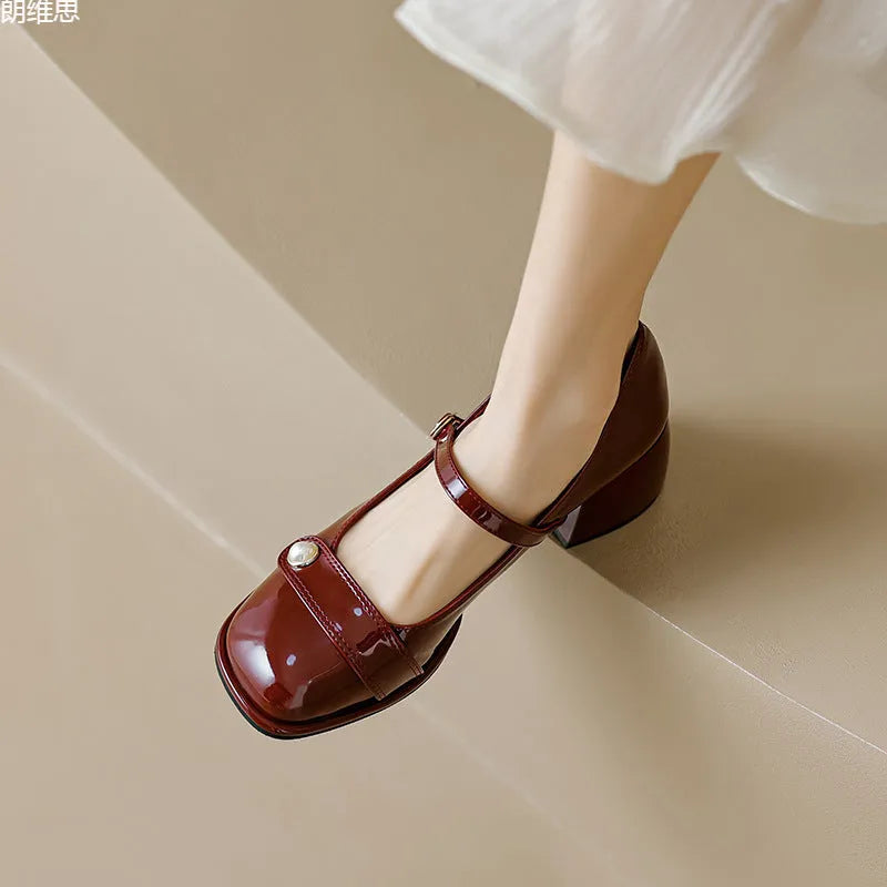 French style chunky heel pump shoes with buckle closure in patent leather, showing square toe design.