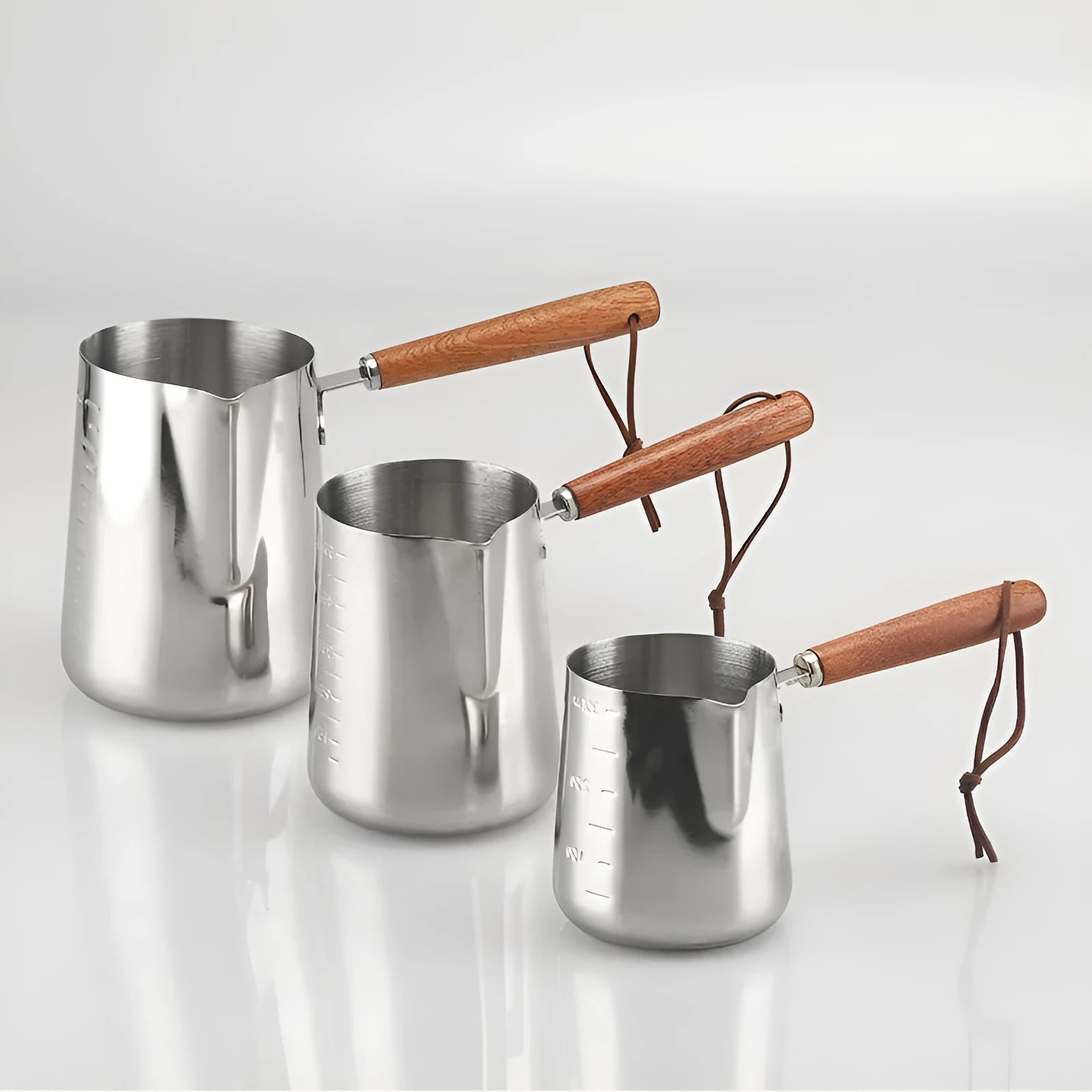 Stainless steel garland coffee cup with wooden handle and interior measurement scale.