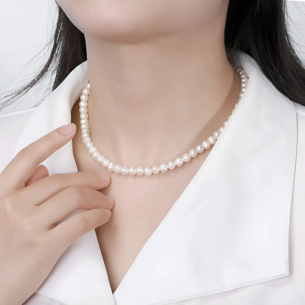 Women's adjustable sterling silver necklace with a single natural freshwater pearl pendant.