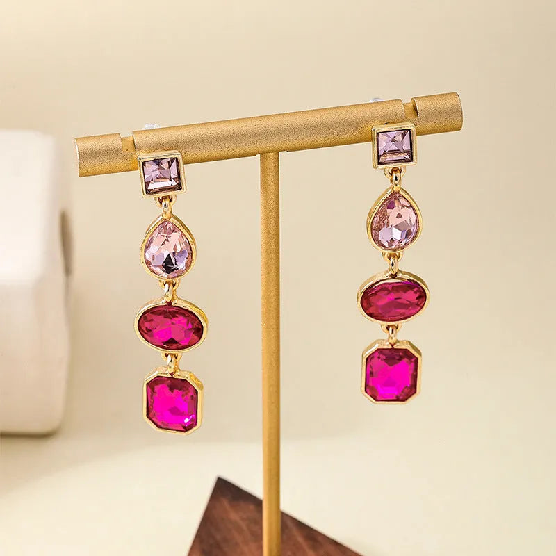 Pair of alloy geometric water drop stud earrings for women in rose red colour
