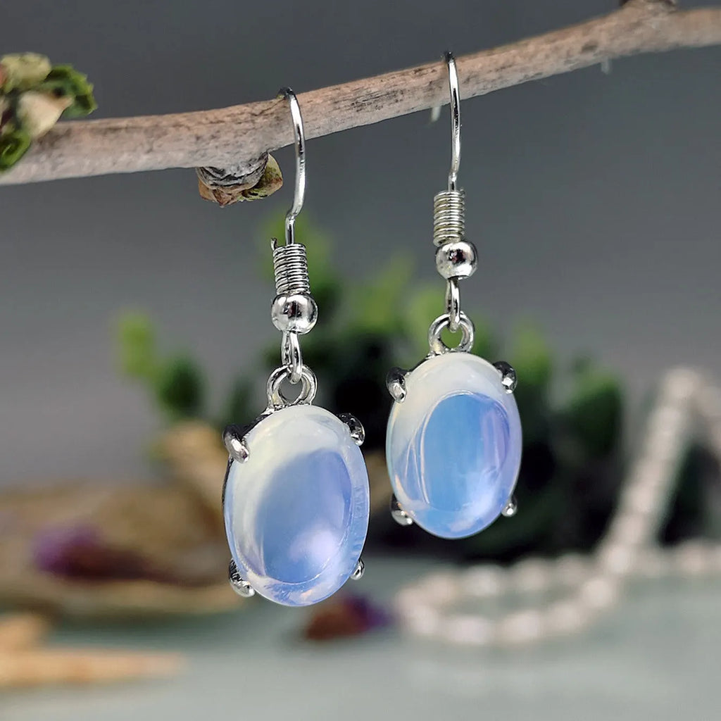 Moonlight white opal earrings with retro cross design and ellipse drop shape