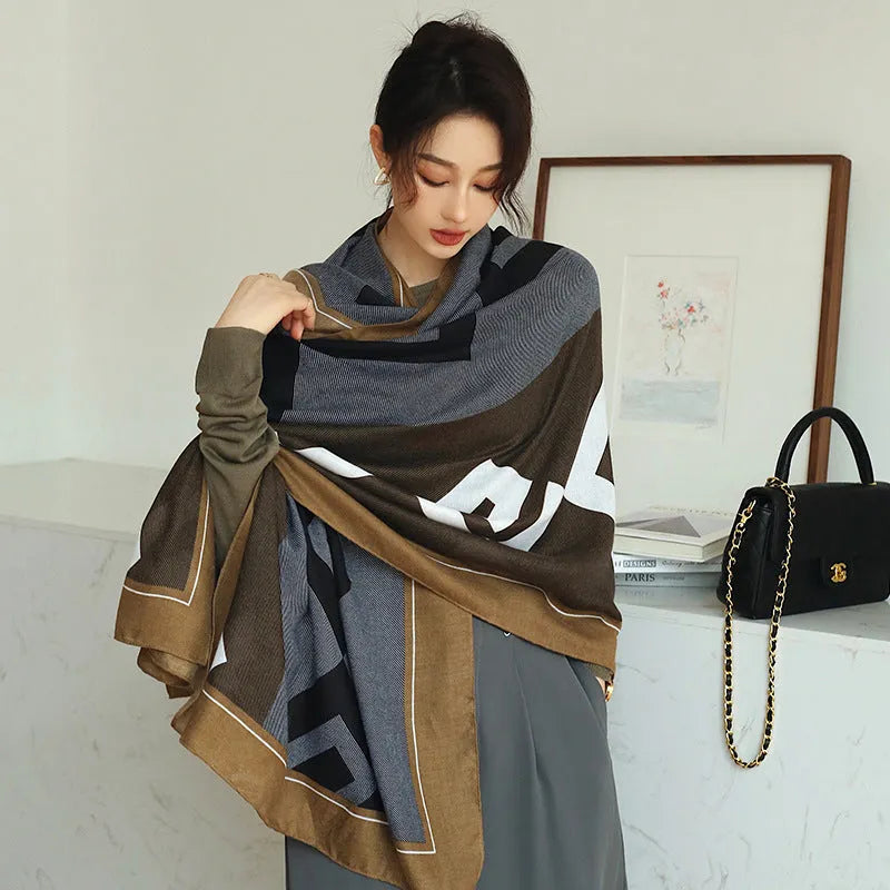 A woman wearing a printed polyester shawl, showcasing one of three available elegant styles, with dimensions of 180cm by 90cm.