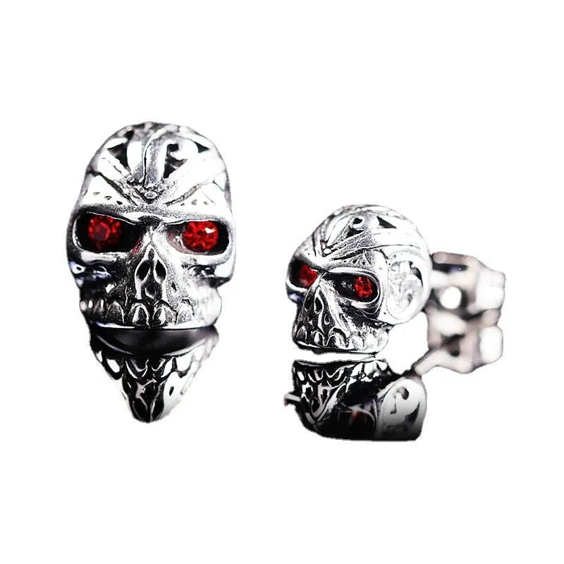 Pair of retro-style skull stud earrings with red gemstone eyes on alloy metal