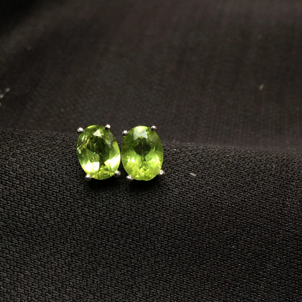 Natural grass green olivine 6x8mm elliptical stud earrings in sterling silver setting
