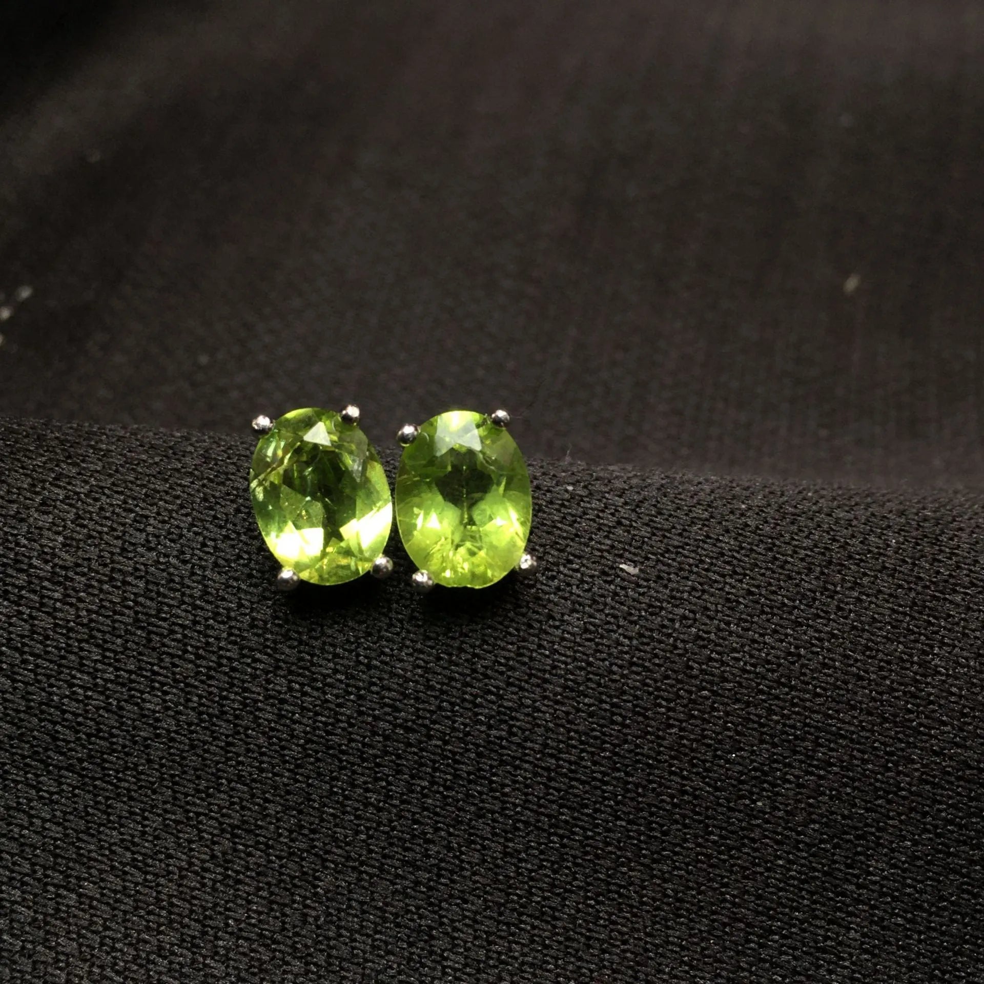 Natural grass green olivine 6x8mm elliptical stud earrings in sterling silver setting
