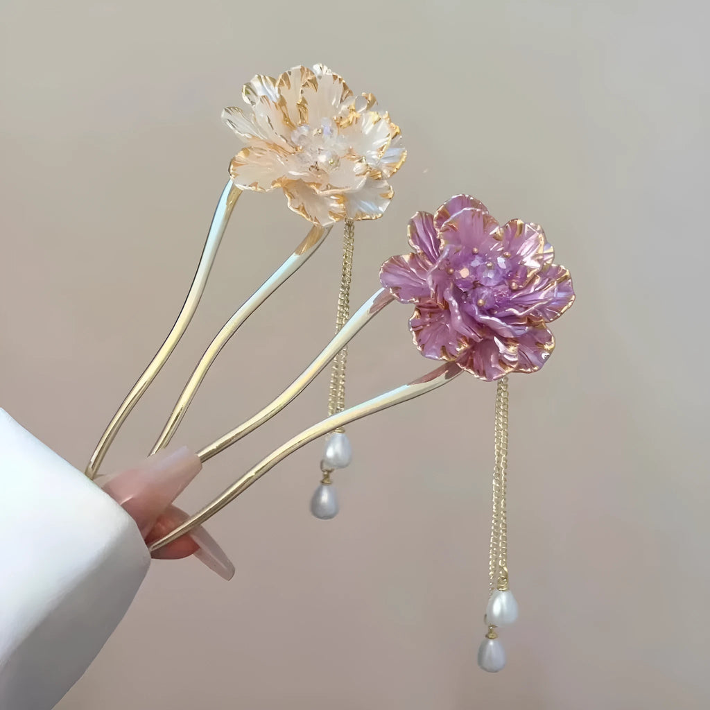 Close-up of a purple peony flower and tassel on a gold-toned U-shaped alloy hairpin.