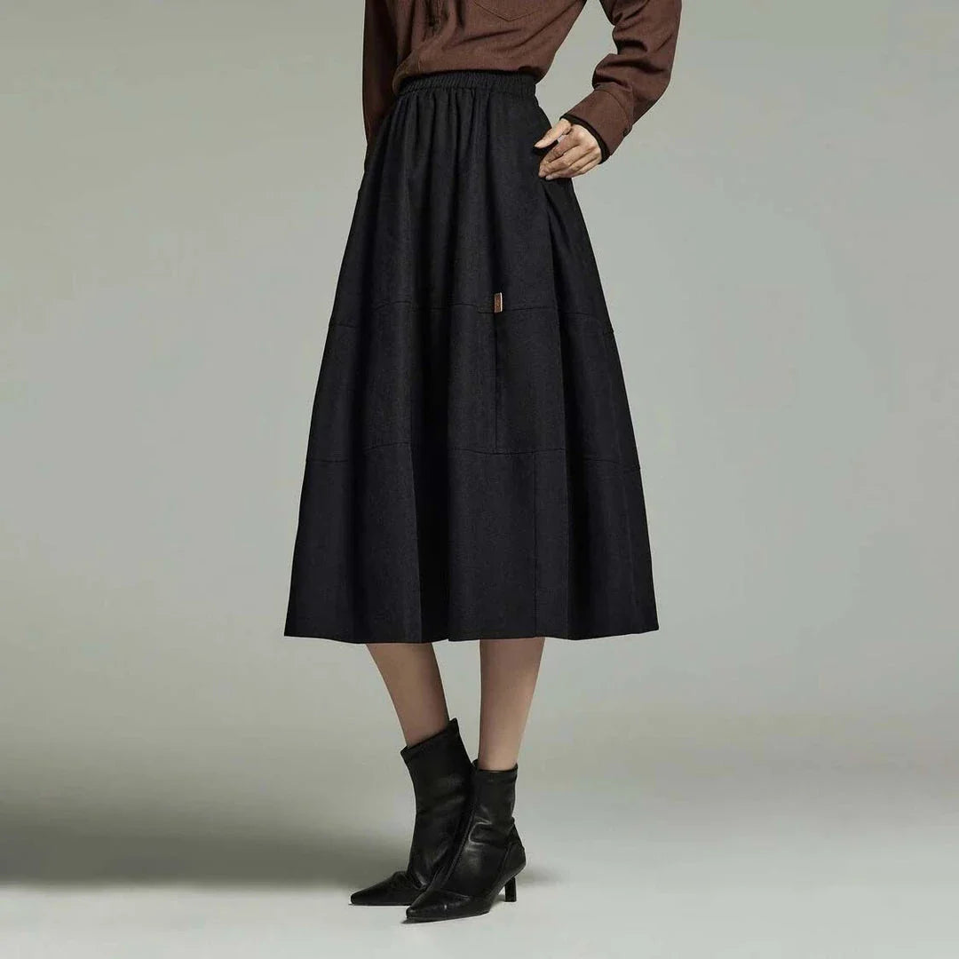 A stylish mid-length pleated skirt with pockets, perfect for winter wear in New Zealand