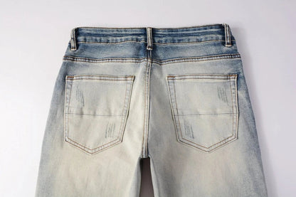 Stylish men's ripped jeans in light blue, featuring a unique distressed look and skinny-fit silhouette inspired by New Zealand's high-street fashion