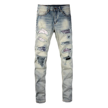 Stylish men's ripped jeans in light blue, featuring a unique distressed look and skinny-fit silhouette inspired by New Zealand's high-street fashion