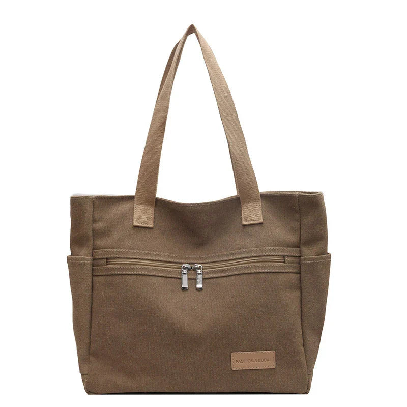 Trendha premium canvas shoulder bags in a range of classic colours, featuring a spacious main compartment and multiple internal pockets for ultimate organization and convenience.