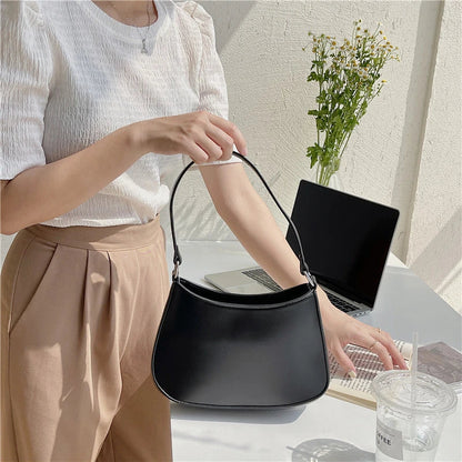 Stylish white underarm bag made of premium PU leather with interior pockets for organization