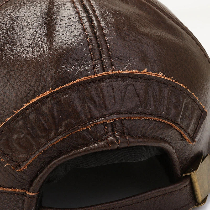 A classic retro-inspired peaked cap made from premium cowhide, providing windproof and thermal protection for Kiwi men.