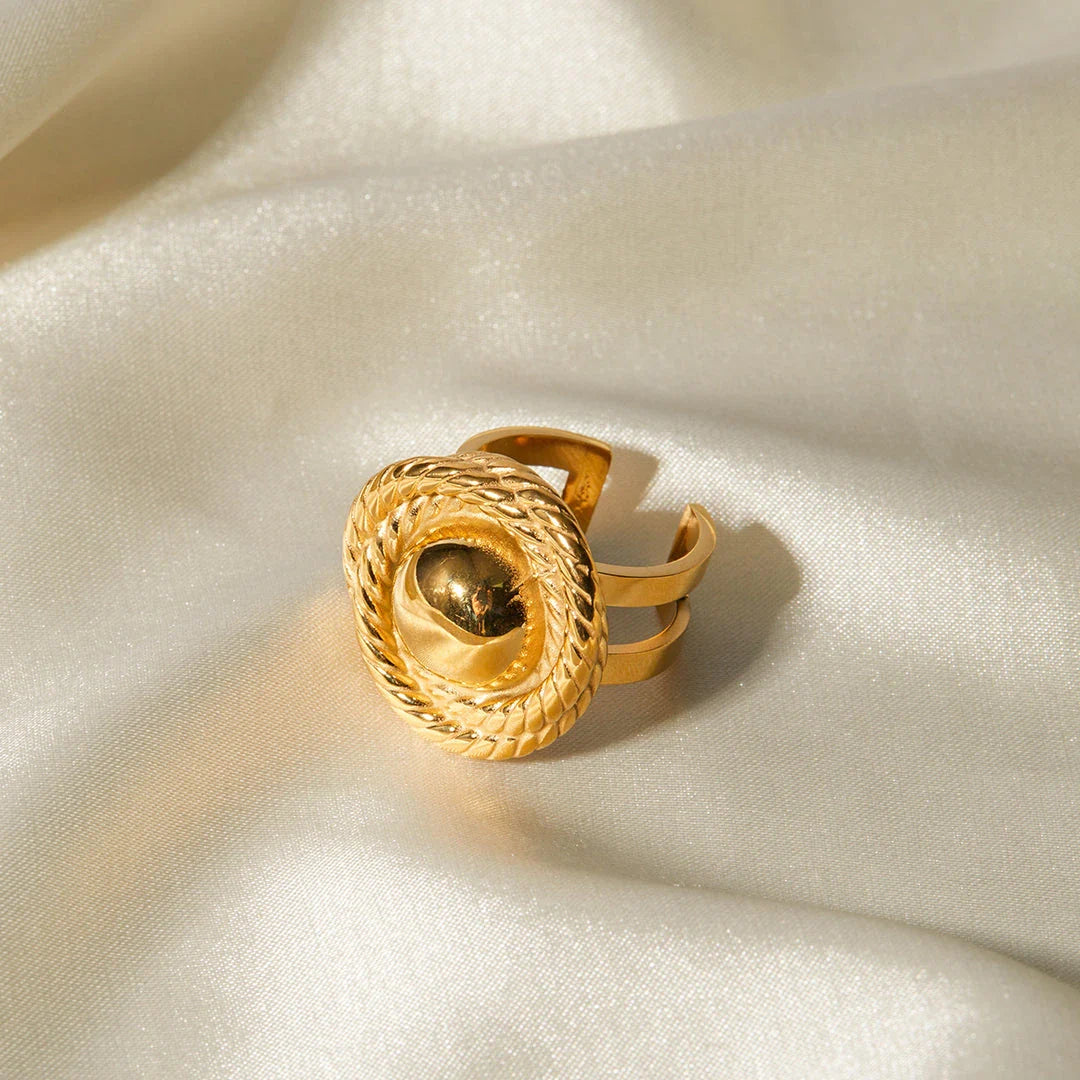 An 18K gold-plated stainless steel spiral loop open ring with a modern and elegant design