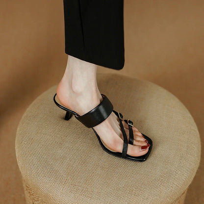 Stylish black leather sandals with a 5.5cm high heel, featuring a chic buckle detail and a slip-resistant outsole for all-day comfort and confidence.