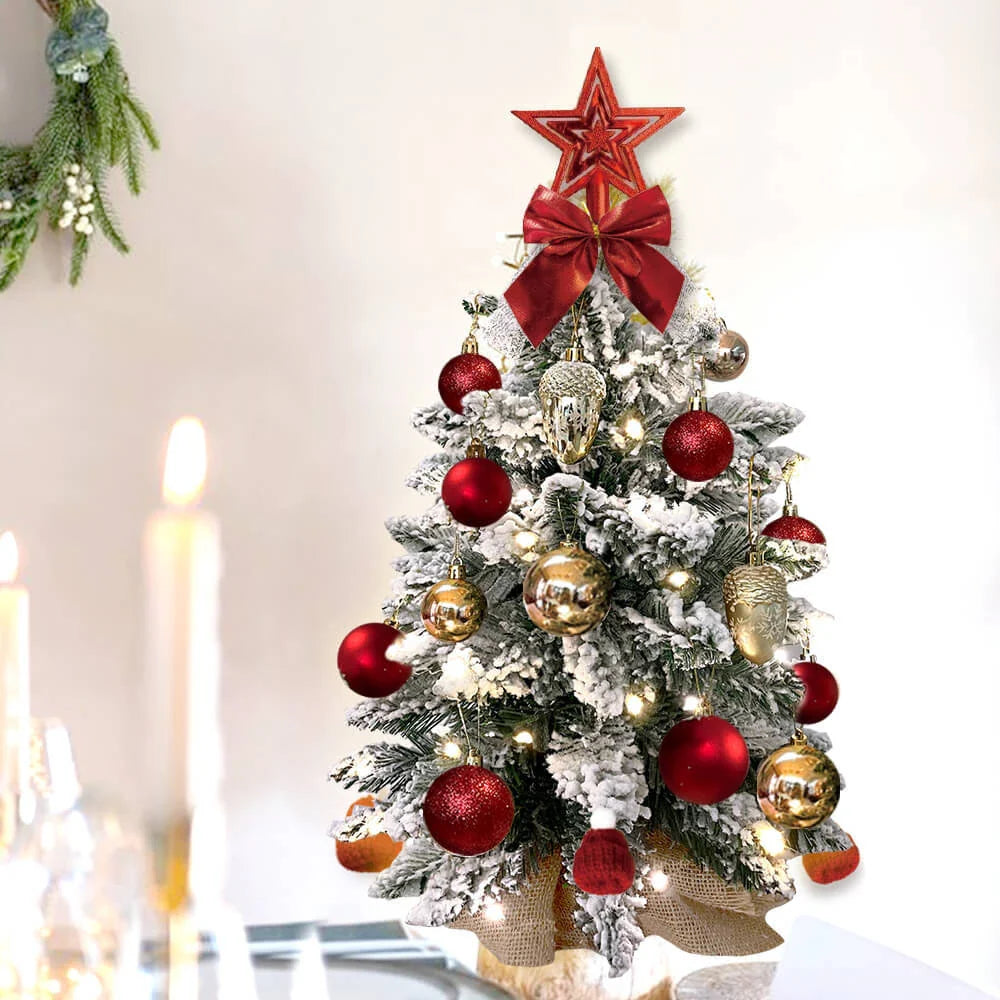 A 2ft mini Christmas tree with flocked snow design, lights, and ornaments for festive tabletop decoration in New Zealand homes and offices.