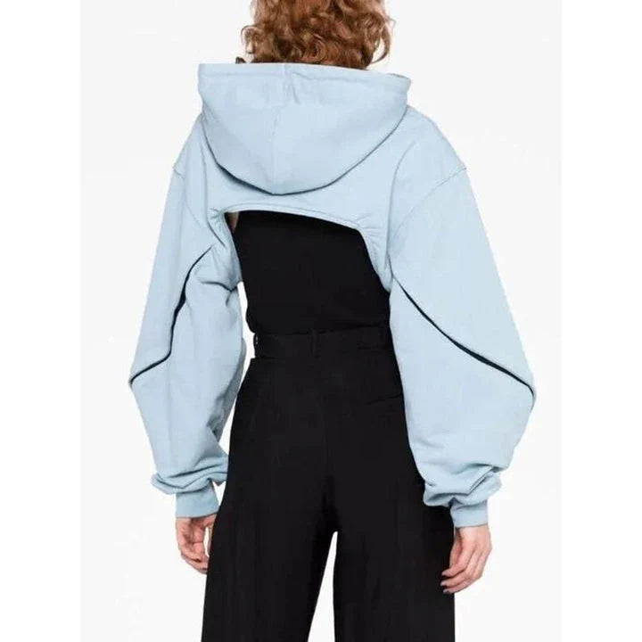 Stylish hooded sweatshirt with open sleeve design and asymmetrical detailing, available in blue and black colors