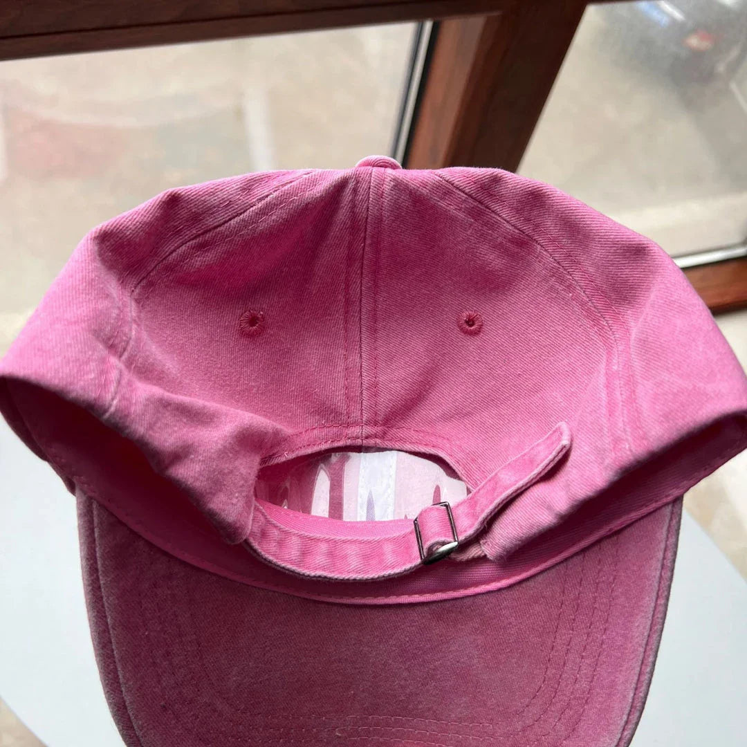 Two pink baseball caps with a cartoon love design, perfect for adding personality to your outfit.