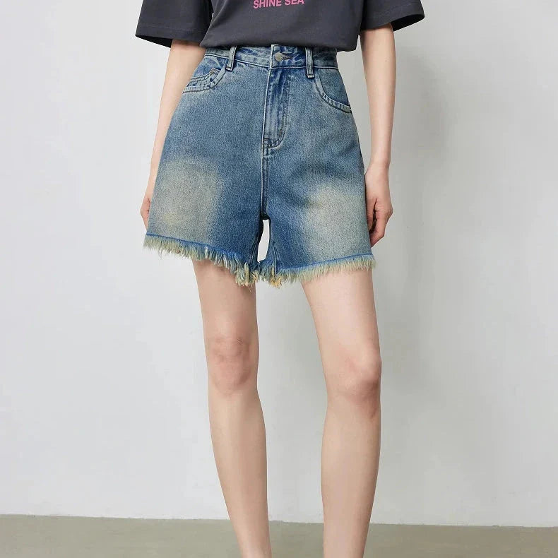 Premium high-waisted denim shorts with playful tassel detailing, perfect for summer outings in New Zealand