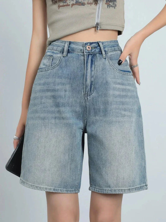 High waist knee-length denim shorts in a classic blue color, perfect for summer wear in New Zealand.