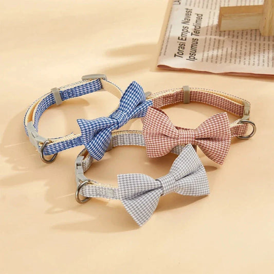 A red checkered pet collar with a delicate butterfly knot detail, designed for stylish and comfortable wear.