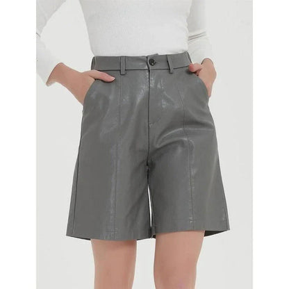 Stylish knee-length PU leather shorts for Kiwi women, featuring a flattering mid-rise waist and elastic waistband for maximum comfort.