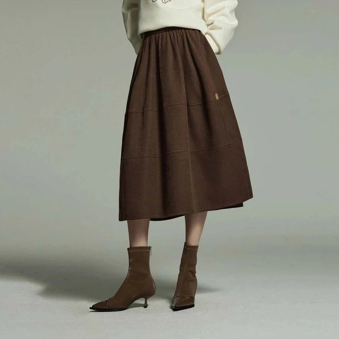 A stylish mid-length pleated skirt with pockets, perfect for winter wear in New Zealand