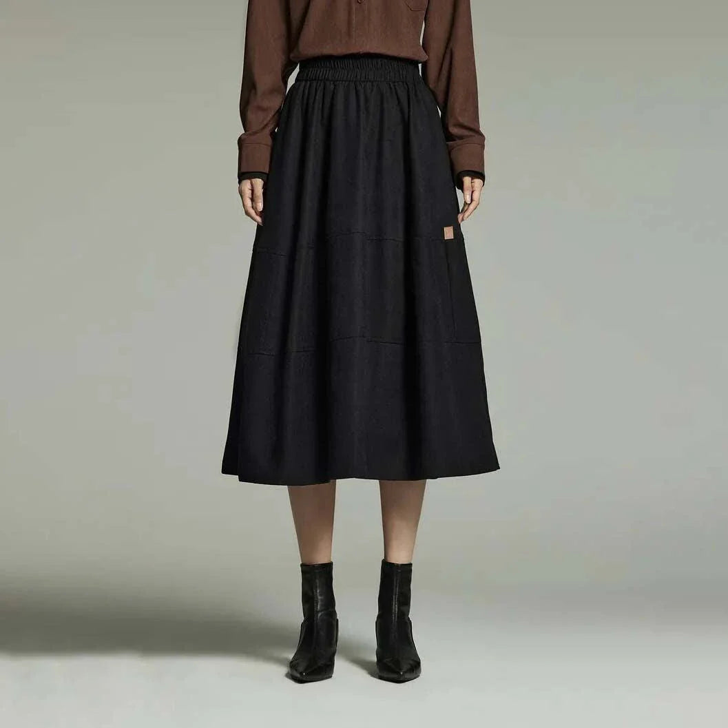 A stylish mid-length pleated skirt with pockets, perfect for winter wear in New Zealand