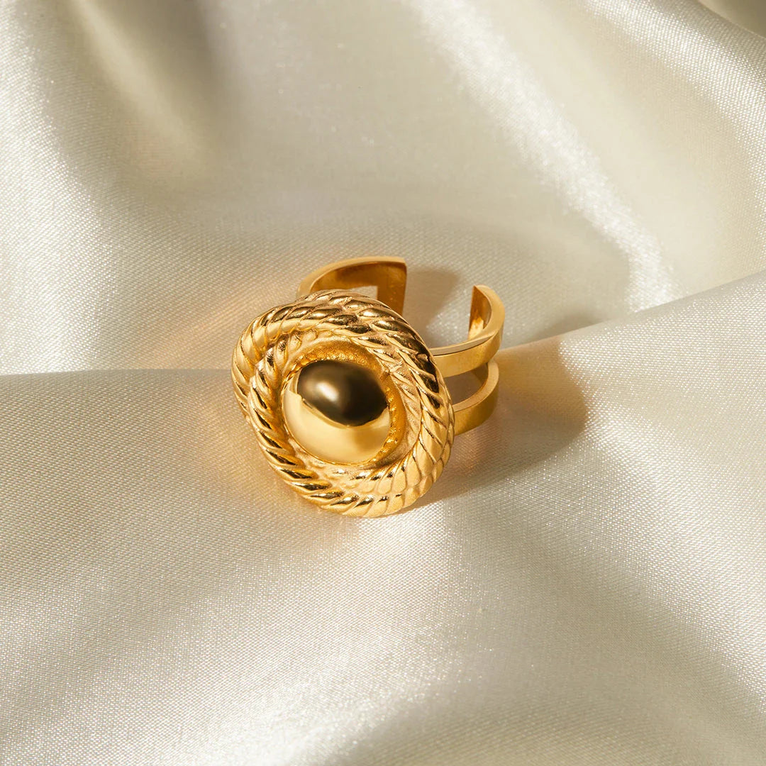 An 18K gold-plated stainless steel spiral loop open ring with a modern and elegant design