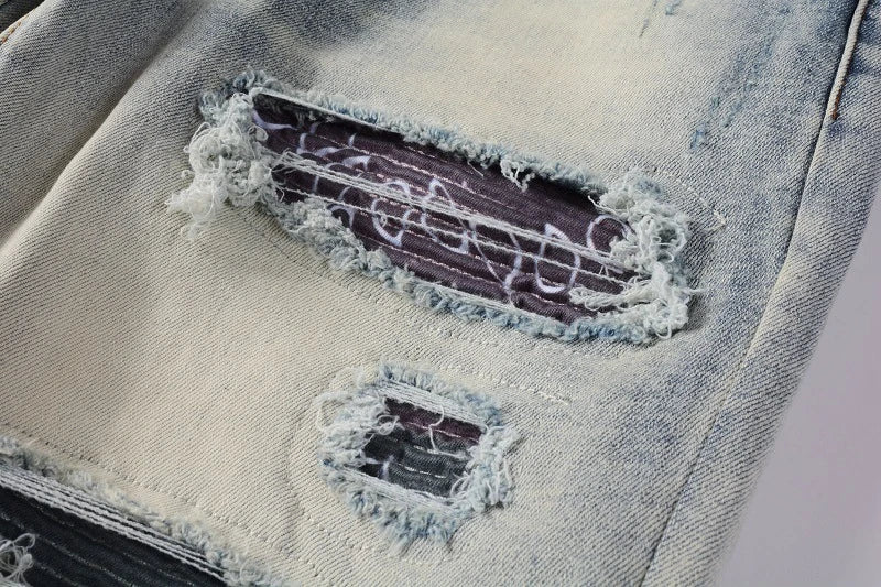 Stylish men's ripped jeans in light blue, featuring a unique distressed look and skinny-fit silhouette inspired by New Zealand's high-street fashion