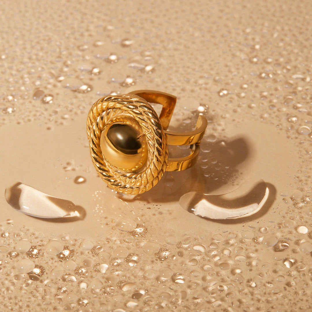 An 18K gold-plated stainless steel spiral loop open ring with a modern and elegant design