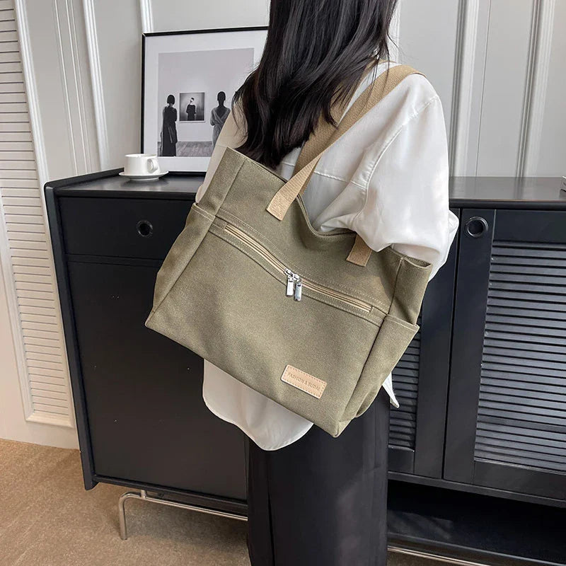 Trendha premium canvas shoulder bags in a range of classic colours, featuring a spacious main compartment and multiple internal pockets for ultimate organization and convenience.