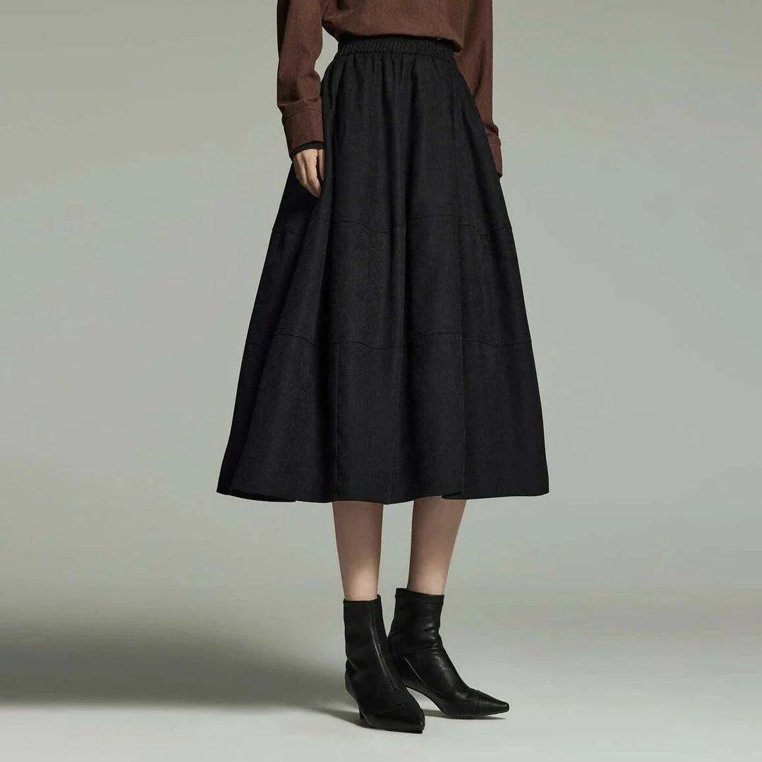 A stylish mid-length pleated skirt with pockets, perfect for winter wear in New Zealand