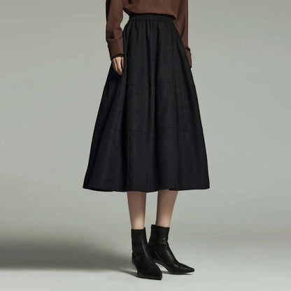 A stylish mid-length pleated skirt with pockets, perfect for winter wear in New Zealand