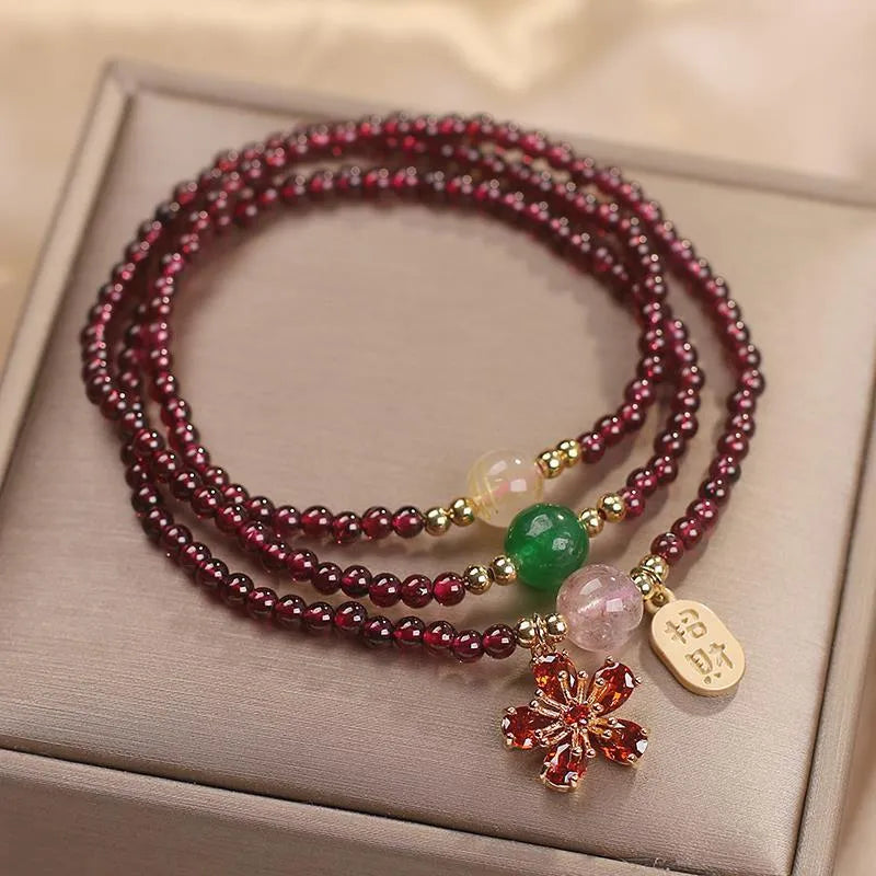 Crystal bracelet for women in pomegranate red cherry blossom colour with sequin details.