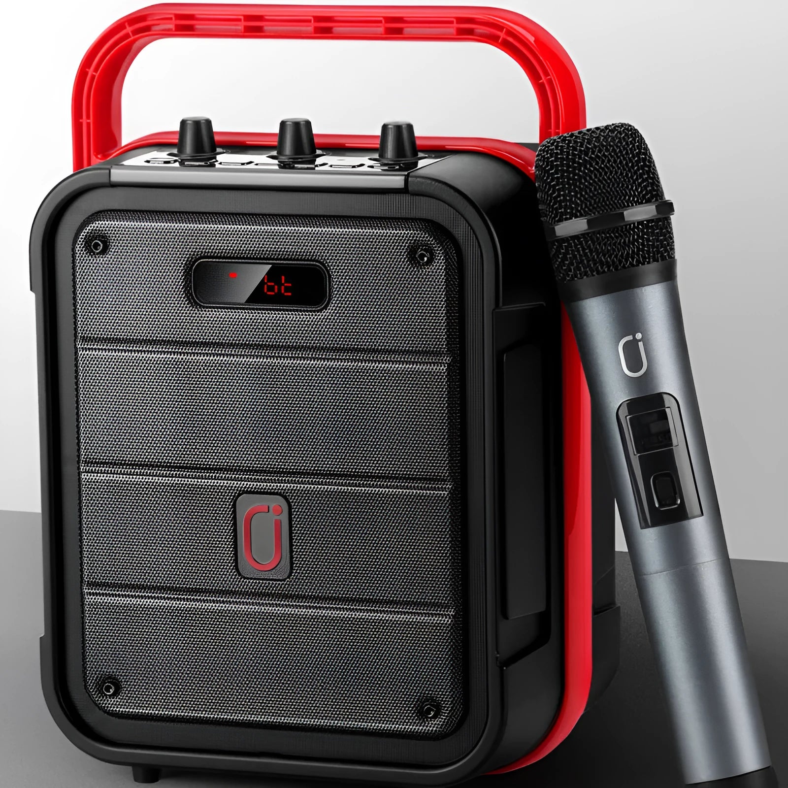 MS62AI portable Bluetooth speaker with wireless microphone on a table, showing control buttons and volume knob.