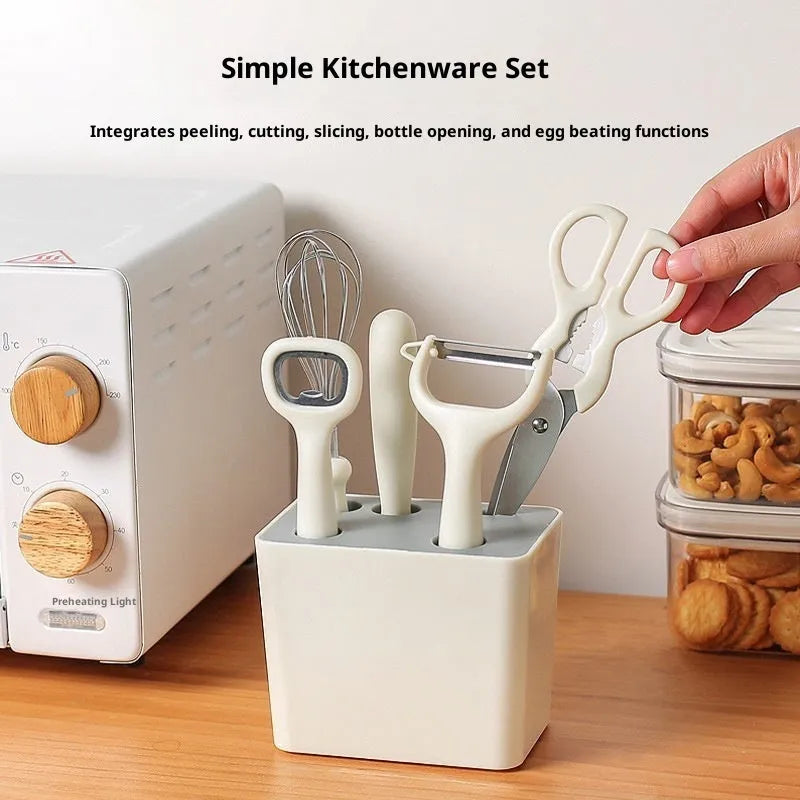 Six-piece white stainless steel kitchen gadget set arranged on a neutral background