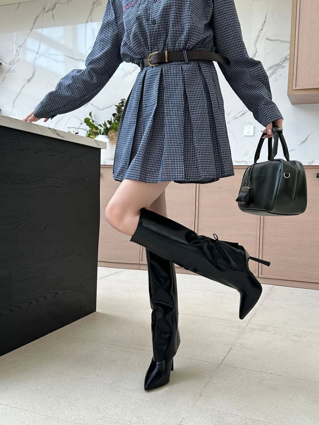 Black slim-fit leg warmer overshoes with a stiletto heel and decorative leather stitching on a faux PU upper.