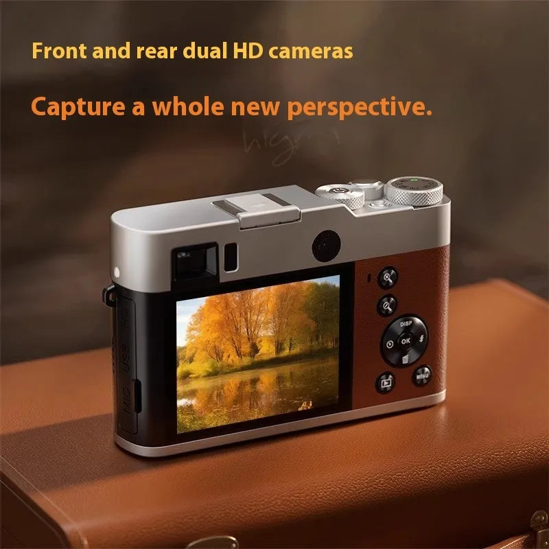 Black 5K digital camera with dual lenses, optical viewfinder, and a 2.88-inch screen on a strap.