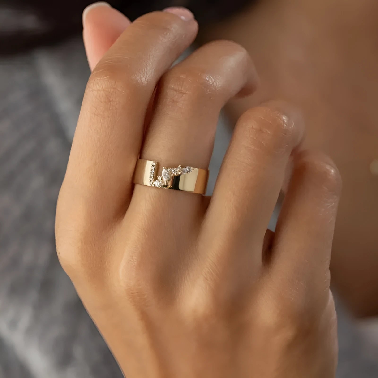 Gold-colour women's ring with zircon centrepiece showing front and side views