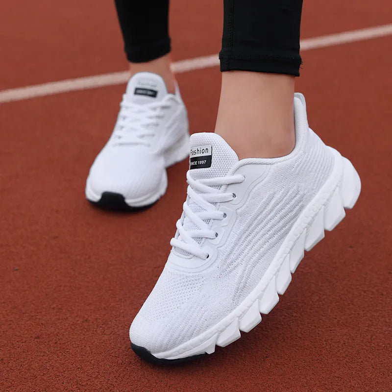 Low-top black and white running sneakers with cross strap design and MD sole