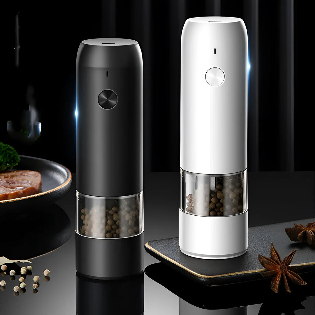 Black and silver rechargeable electric pepper grinder with clear acrylic body on a kitchen counter