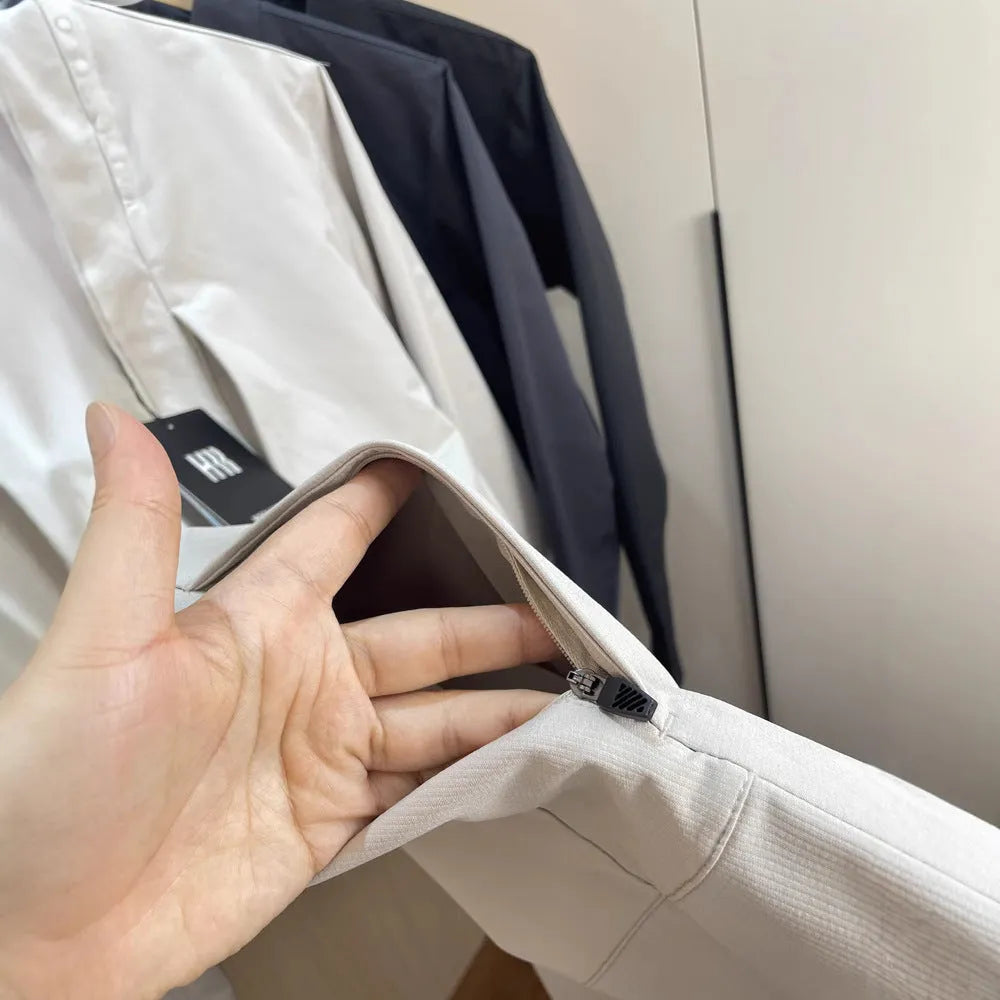 Man wearing a beige stand collar polyester casual jacket with long sleeves and a straight hem.